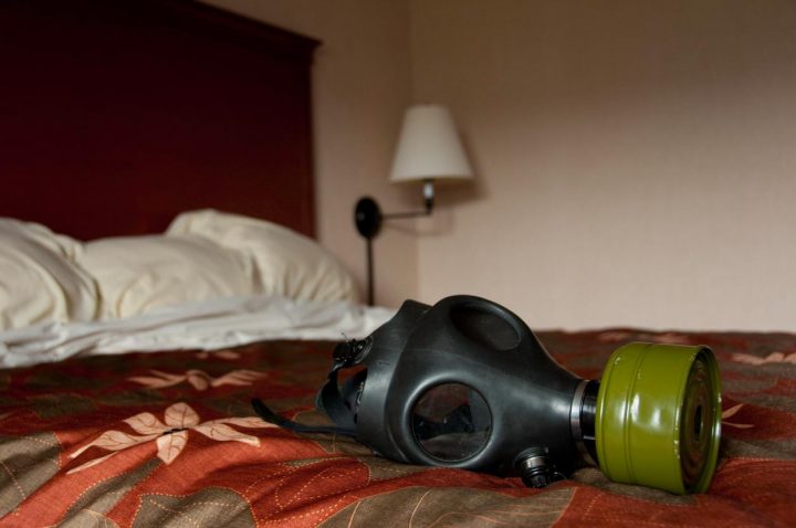 A gas mask sits on a memory foam mattress