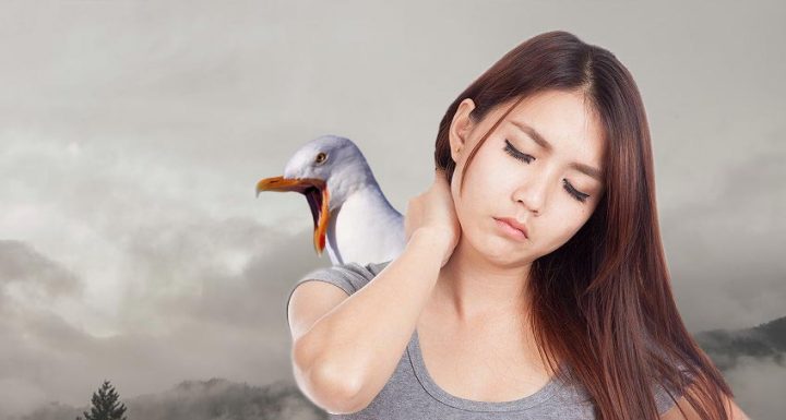 Woman has a stiff neck from turning around too quickly